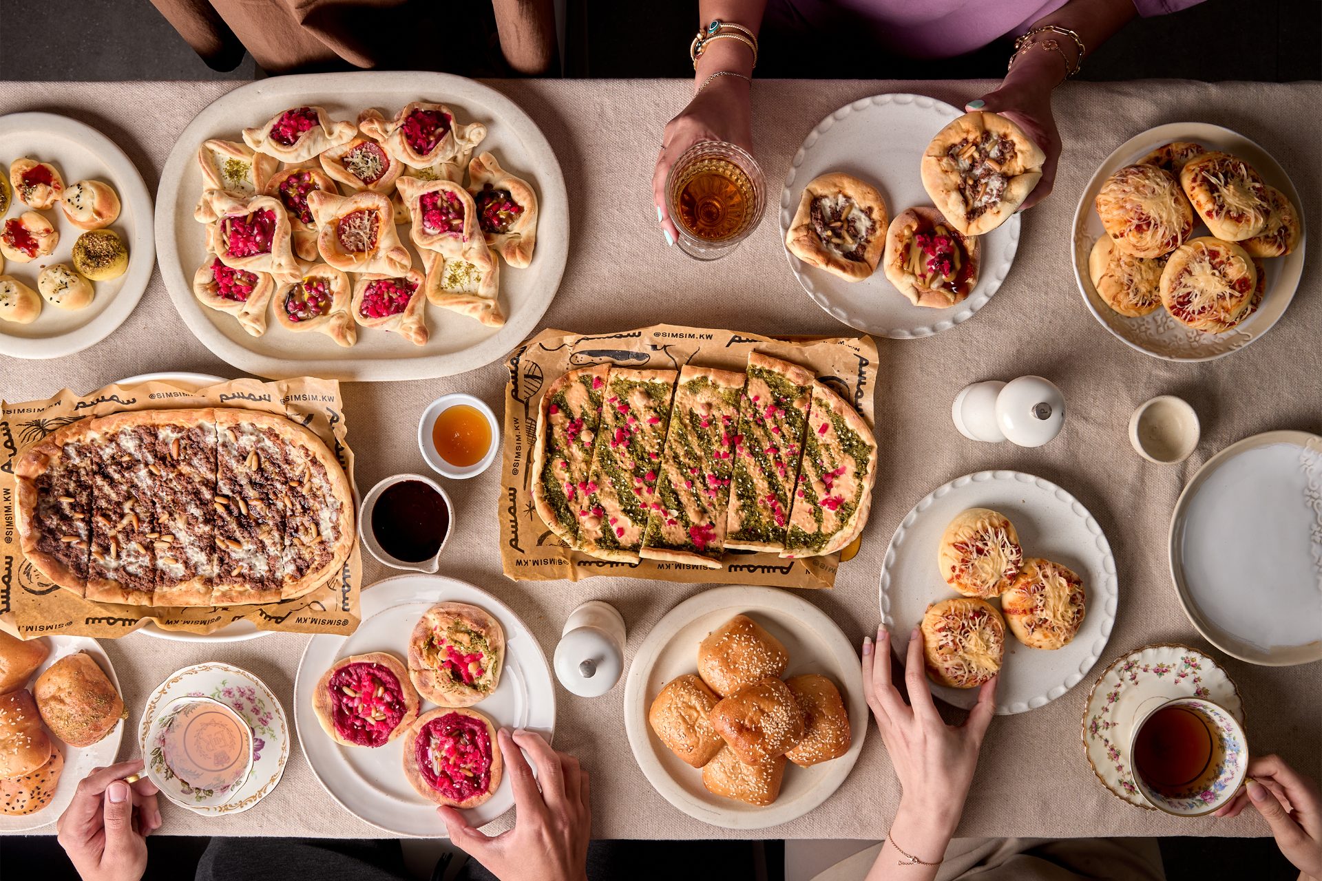 A Simsim table spread of manakish, pide and buns